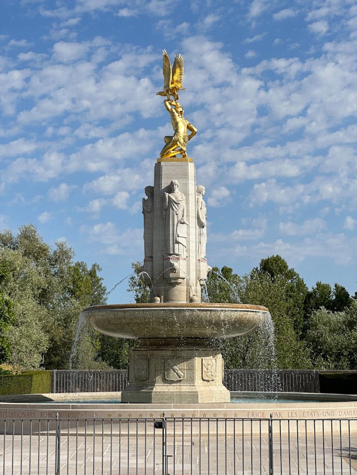 Crafting Captivating Headlines: Your awesome post title goes here Stunning view of the Fontaine des Etats-Unis in Tours, featuring golden statue and intricate carvings.