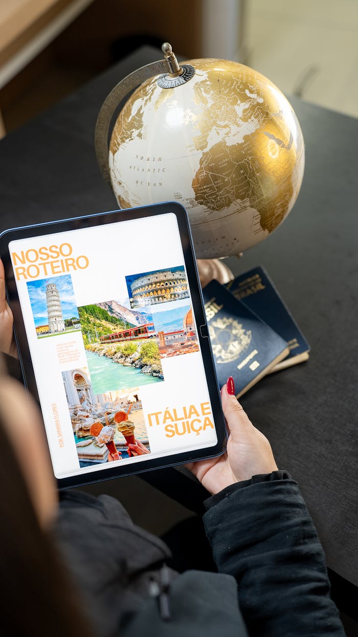 about-02 Traveler planning a trip to Italy and Switzerland using a globe, tablet, and passports.